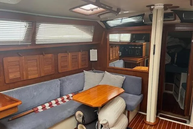 Slide: The Image of Interior of 1987 Irwin 43 Mk II Cruiser with cozy seating and wooden accents. - 24