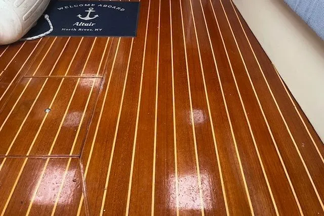 Slide: The Image of Polished wooden deck of 1987 Irwin 43 Mk II Cruiser, featuring welcome mat. - 27