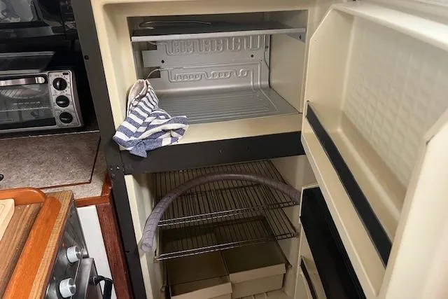 Slide: The Image of 1987 Irwin 43 Mk II Cruiser kitchen with open fridge and striped towel. - 35