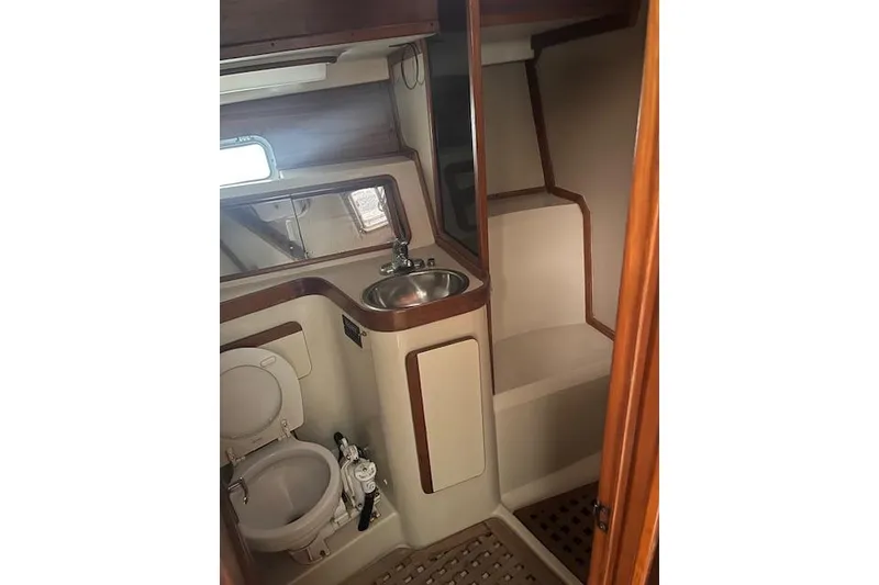 Slide: The Image of 1987 Irwin 43 Mk II Cruiser bathroom with sink, toilet, and wooden accents. - 38