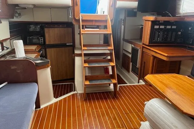 Slide: The Image of Interior of 1987 Irwin 43 Mk II Cruiser with wooden flooring and compact kitchen area. - 39