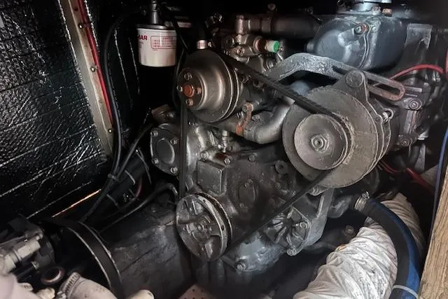 Slide: The Image of Engine compartment of a 1987 Irwin 43 Mk II Cruiser, showcasing mechanical components and belts. - 42