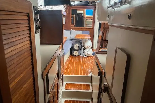 Slide: The Image of Interior of 1987 Irwin 43 Mk II Cruiser with wooden flooring and cozy seating area. - 50