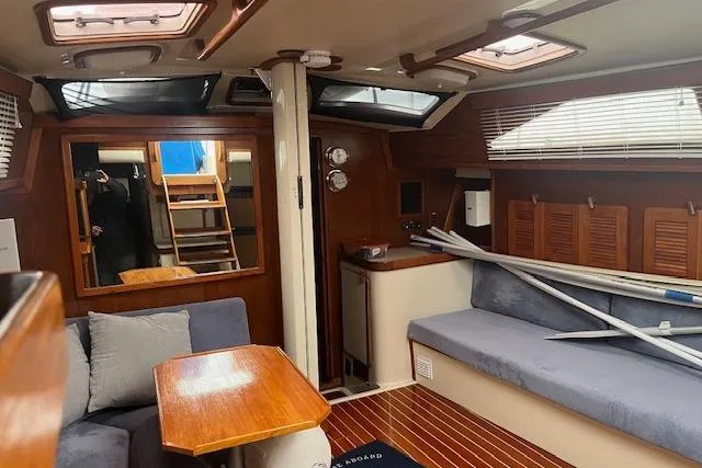 Slide: The Image of Interior of 1987 Irwin 43 Mk II Cruiser, featuring cozy seating and wooden accents. - 52