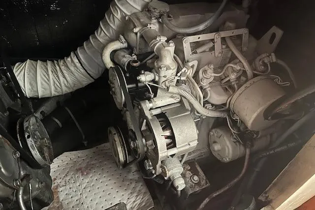 Slide: The Image of Engine compartment of a 1987 Irwin 43 Mk II Cruiser, showcasing mechanical components and hoses. - 54