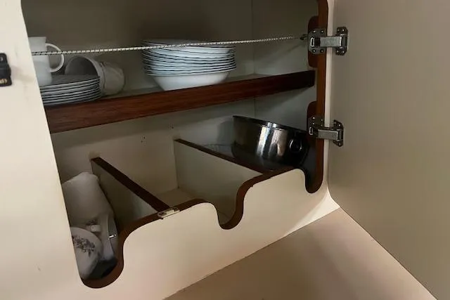 Slide: The Image of Cabinet interior with dishes and cookware on an Irwin 43 Mk II Cruiser, 1987. - 55