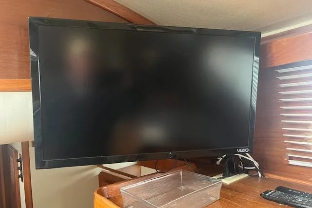 Slide: The Image of Vizio TV inside 1987 Irwin 43 Mk II Cruiser, wooden interior, remote control visible. - 58