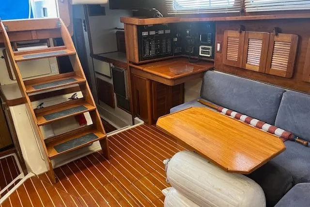 Slide: The Image of 1987 Irwin 43 Mk II Cruiser interior with wooden stairs, seating, and navigation panel. - 63