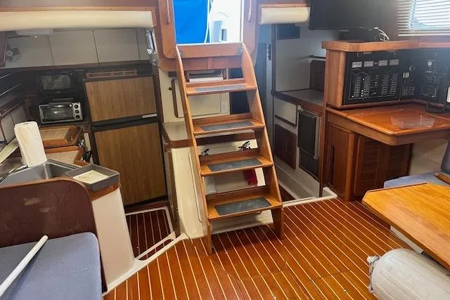 Slide: The Image of Interior of 1987 Irwin 43 Mk II Cruiser with wooden flooring and compact kitchen. - 65