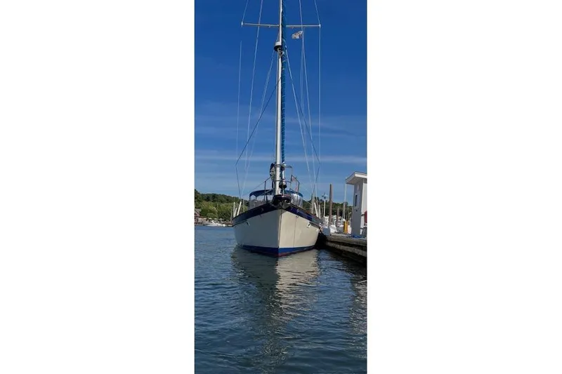 Slide: The Image of 1987 Irwin 43 Mk II Cruiser docked at a marina under clear blue skies. - 8