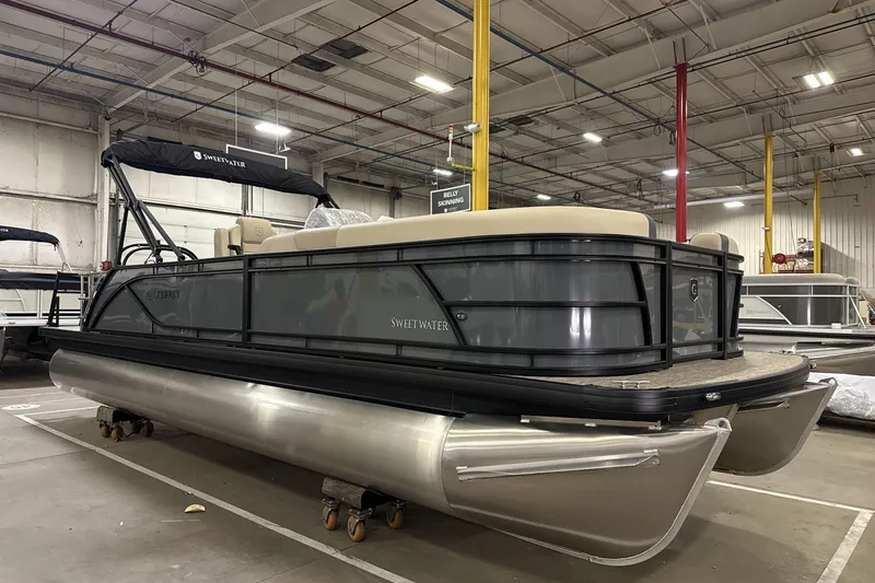 Slide: The Image of 2026 Godfrey Sweetwater 2286 SFL pontoon boat in a warehouse setting. - 1