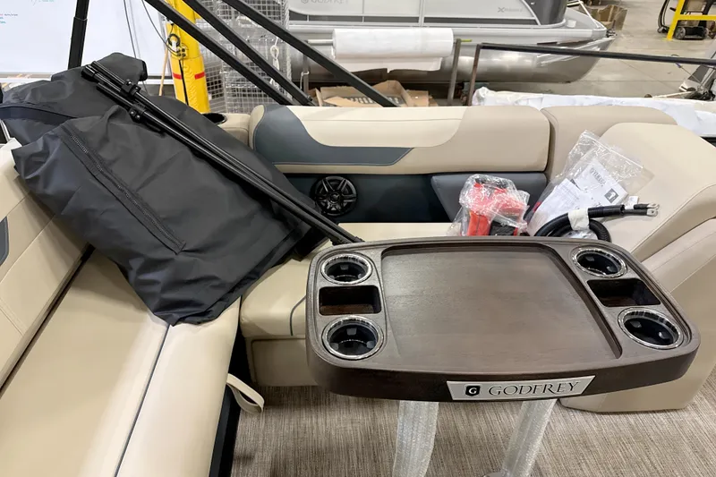 Slide: The Image of 2026 Godfrey Sweetwater 2286 SFL boat interior with table and seating. - 11