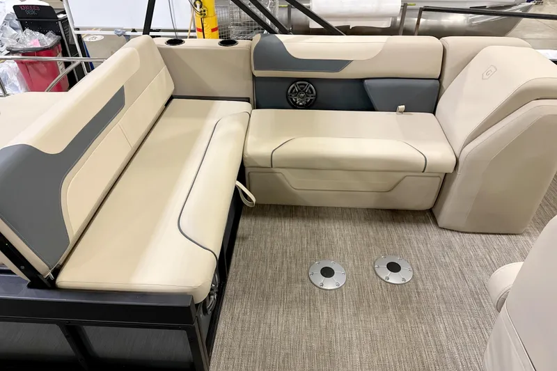 Slide: The Image of 2026 Godfrey Sweetwater 2286 SFL boat interior with beige seating and carpeted floor. - 2