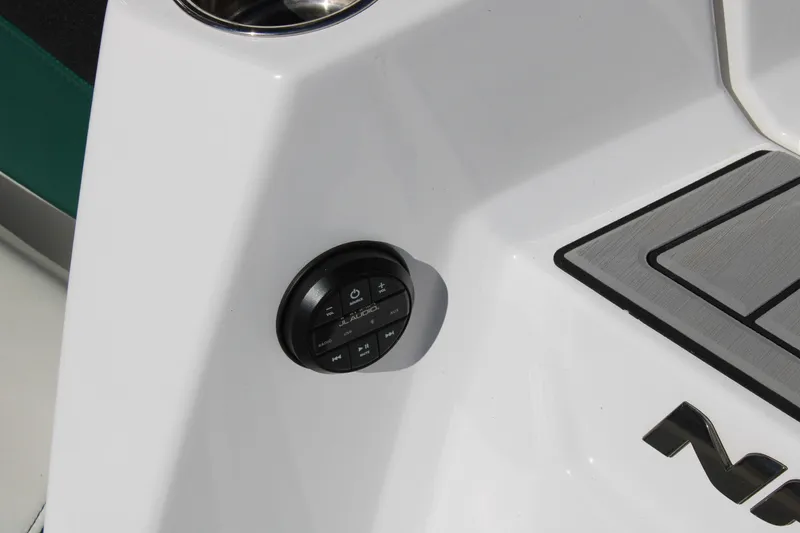 Slide: The Image of 2021 Nautique Super Air Nautique G21 audio control panel on white boat surface. - 12