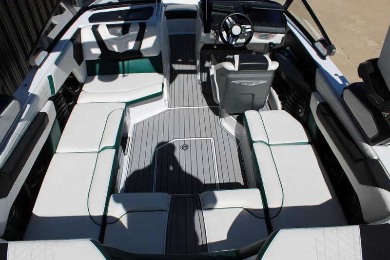 Slide: The Image of 2021 Nautique Super Air Nautique G21 interior with luxurious seating and modern dashboard. - 13
