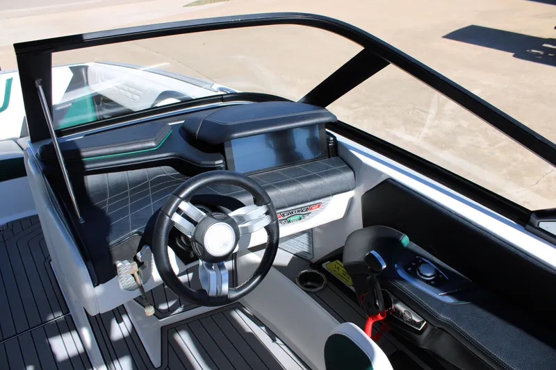 Slide: The Image of 2021 Nautique Super Air Nautique G21 boat interior with modern steering and dashboard. - 15