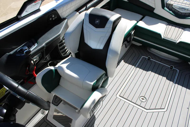 Slide: The Image of 2021 Nautique Super Air Nautique G21 interior with sleek captain's chair and modern dashboard. - 18