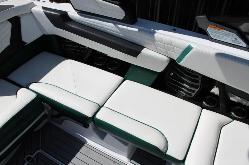Slide: The Image of 2021 Nautique Super Air Nautique G21 interior seating with white and green upholstery. - 21