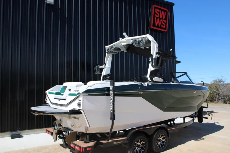 Slide: The Image of 2021 Nautique Super Air Nautique G21 boat on trailer outside SWWS building. - 6