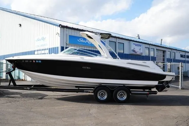 Slide: The Image of 2008 Sea Ray SLX 250 boat on trailer outside dealership. - 1