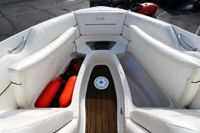 Slide: The Image of 2008 Sea Ray SLX 250 boat interior with white seating and wooden flooring. - 10
