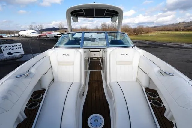 Slide: The Image of 2008 Sea Ray SLX 250 boat interior with white seating and open deck view. - 11