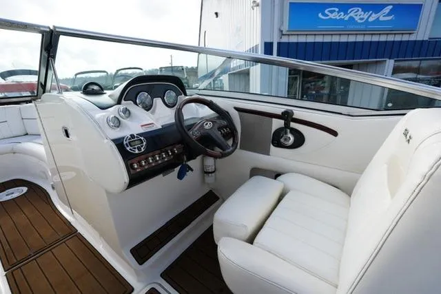 Slide: The Image of 2008 Sea Ray SLX 250 boat interior with white seating and wooden accents. - 13