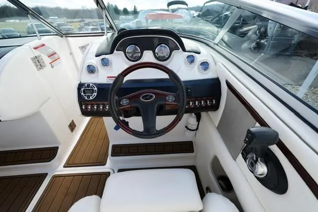 Slide: The Image of 2008 Sea Ray SLX 250 boat cockpit with steering wheel and control panel. - 14