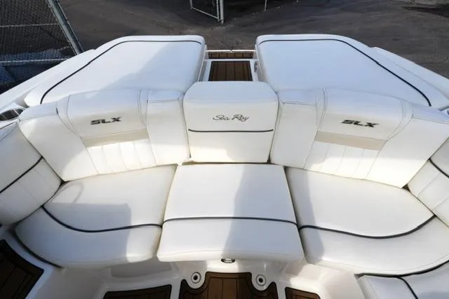 Slide: The Image of 2008 Sea Ray SLX 250 boat with white cushioned seating and branded embroidery. - 16