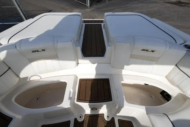Slide: The Image of 2008 Sea Ray SLX 250 boat interior with white seating and wood accents. - 17