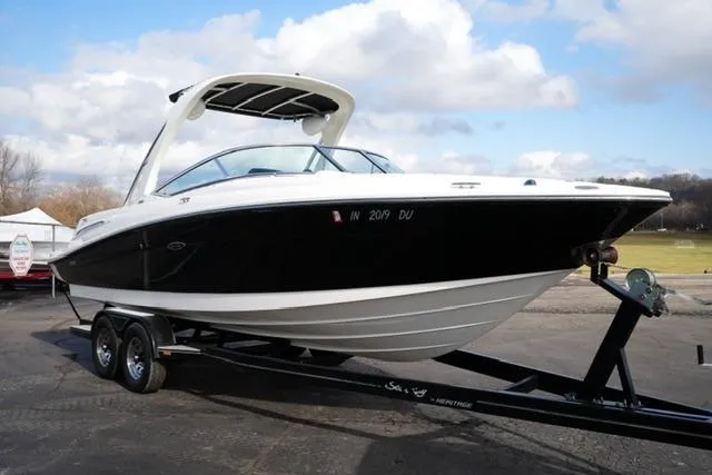 Slide: The Image of 2008 Sea Ray SLX 250 boat on trailer, parked outdoors under a cloudy sky. - 3