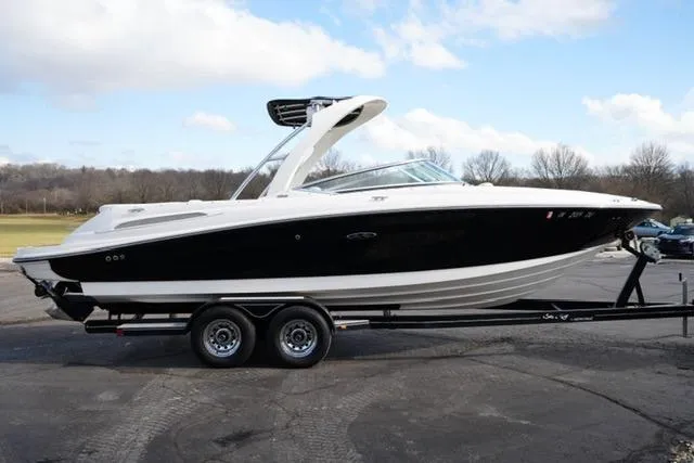 Slide: The Image of 2008 Sea Ray SLX 250 boat on trailer, black and white design, parked outdoors. - 4