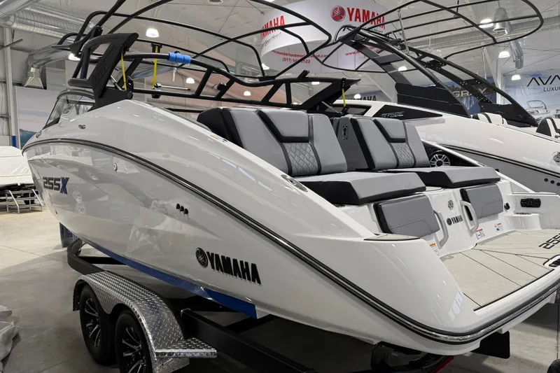 Slide: The Image of 2026 Yamaha Boats 255XE displayed indoors, showcasing sleek design and modern features. - 2