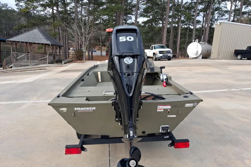 Slide: The Image of 2023 G3 Gator Tough 18 CC boat with 50 HP motor in a parking area. - 5