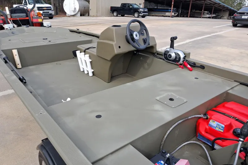 Slide: The Image of 2023 G3 Gator Tough 18 CC boat interior with steering console and equipment. - 6