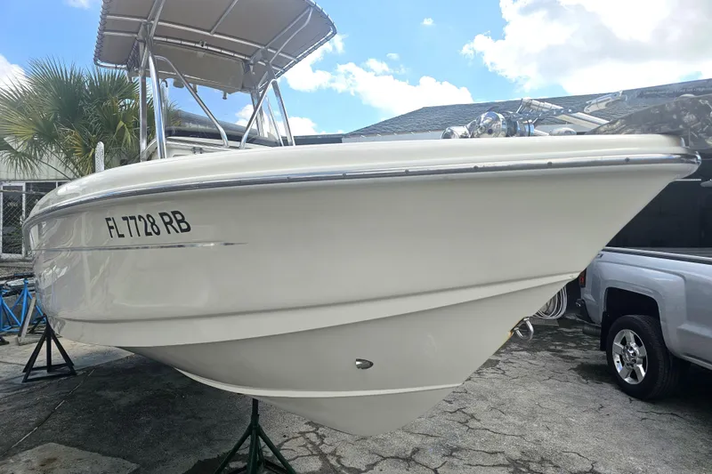 Slide: The Image of 2016 Scout 210 XSF boat with registration FL 7728 RB, parked outdoors. - 21