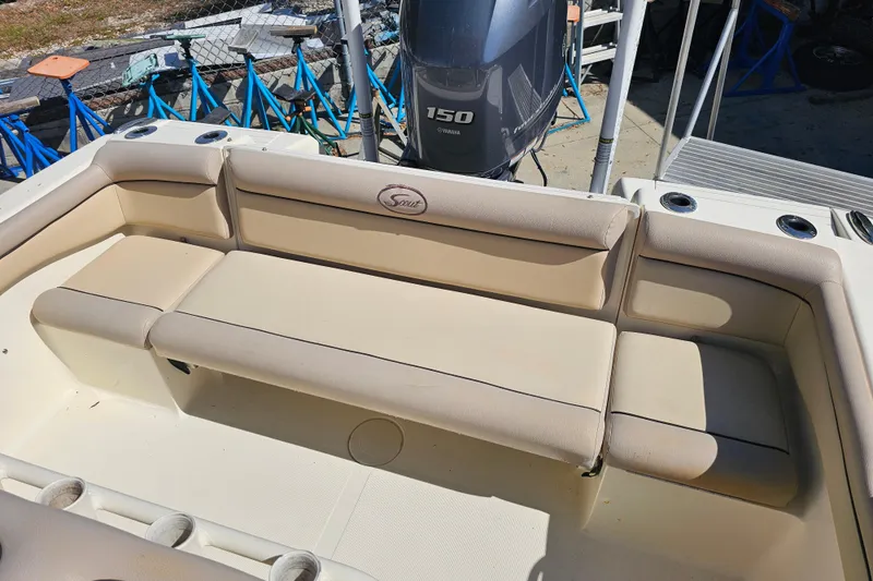 Slide: The Image of 2016 Scout 210 XSF boat interior with beige seating and Yamaha 150 engine. - 28