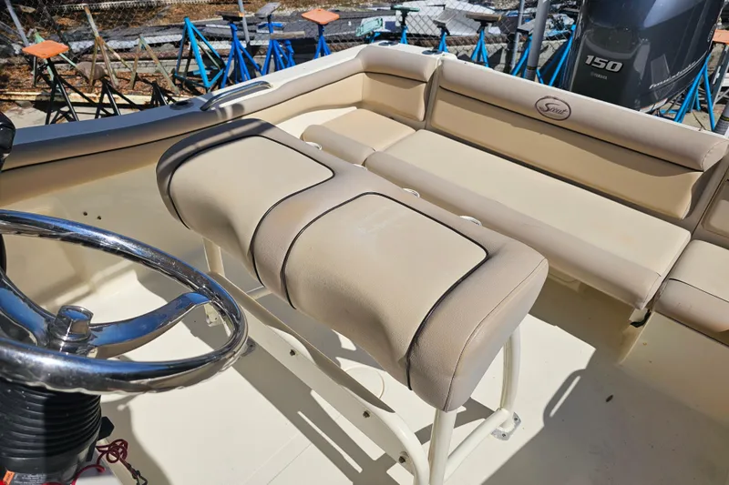 Slide: The Image of 2016 Scout 210 XSF boat interior with beige seating and steering wheel. - 29