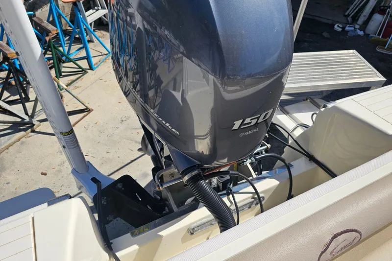 Slide: The Image of 2016 Scout 210 XSF boat with Yamaha 150 outboard motor, docked outdoors. - 34