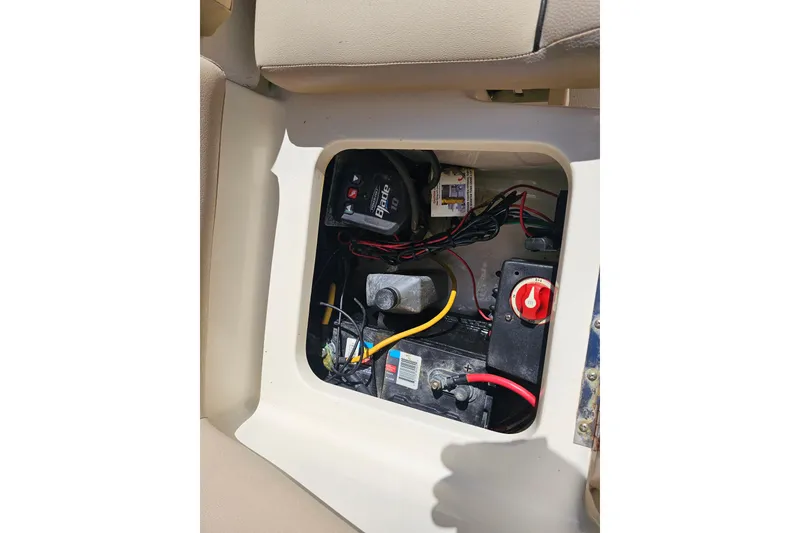 Slide: The Image of 2016 Scout 210 XSF boat battery compartment with wiring and switch. - 37