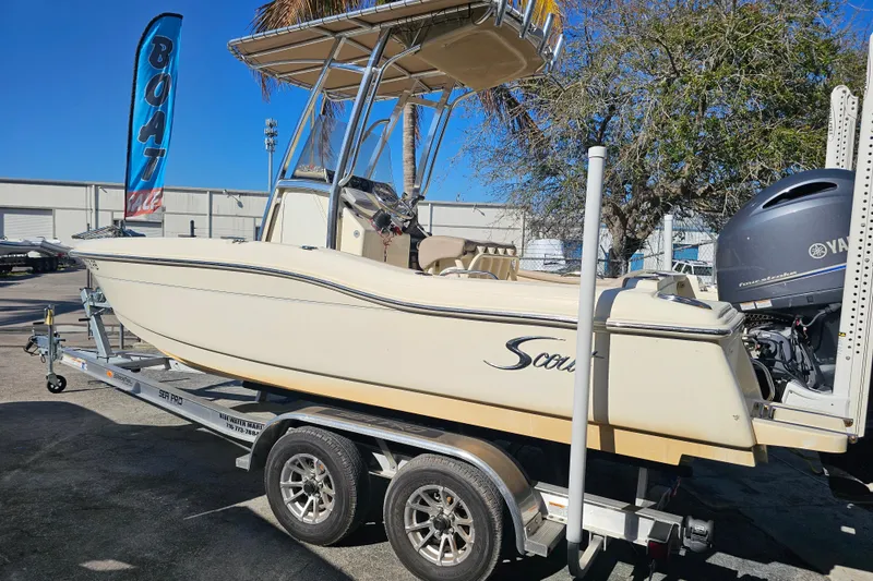 Slide: The Image of 2016 Scout 210 XSF boat with Yamaha 150 engine, parked outdoors. - 4