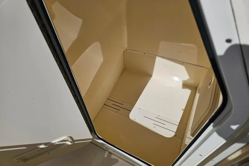 Slide: The Image of 2016 Scout 210 XSF boat storage compartment, open and empty, with clean interior. - 40