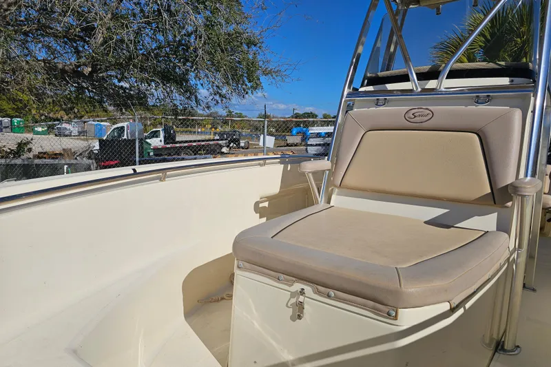 Slide: The Image of 2016 Scout 210 XSF boat interior with beige seating and stainless steel accents. - 9