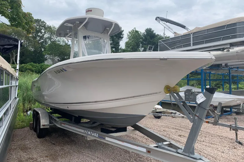 The Image of 2015 Tidewater 220 CC Adventure boat on trailer, parked outdoors. - 0