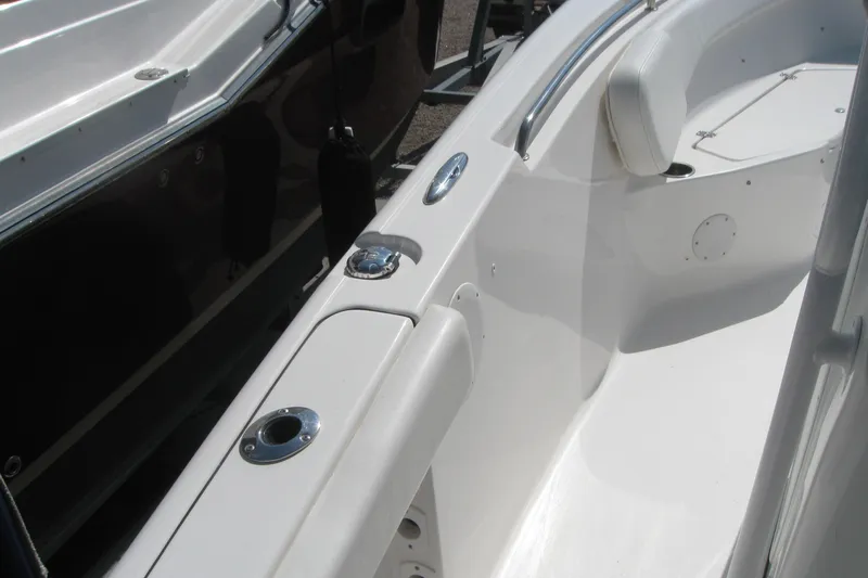 Slide: The Image of 2015 Tidewater 220 CC Adventure boat interior with seating and stainless steel fixtures. - 10
