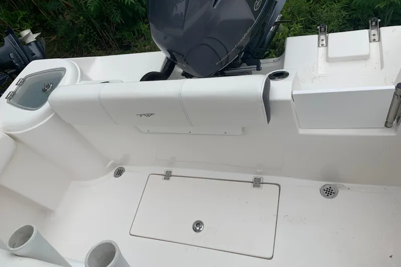 Slide: The Image of 2015 Tidewater 220 CC Adventure boat interior with motor and storage compartments. - 12
