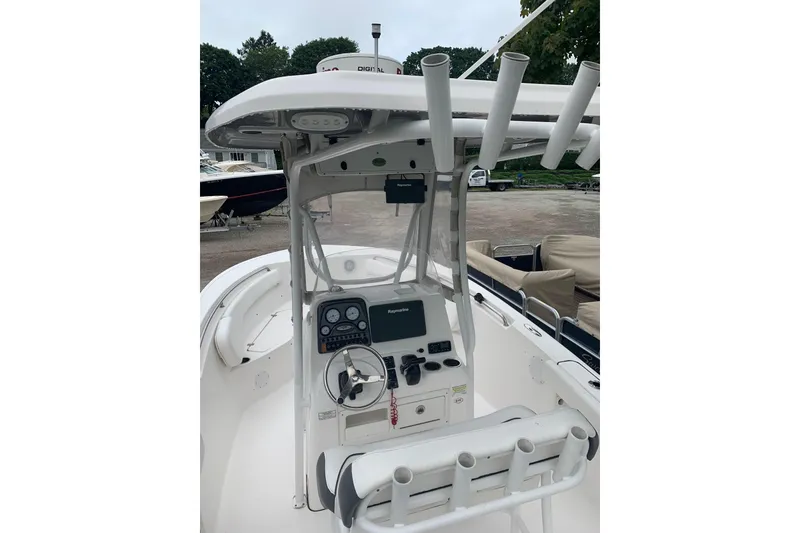 Slide: The Image of 2015 Tidewater 220 CC Adventure boat cockpit with steering wheel and controls. - 2