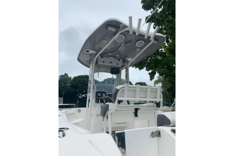Slide: The Image of 2015 Tidewater 220 CC Adventure boat with T-top and rod holders, viewed from the deck. - 3