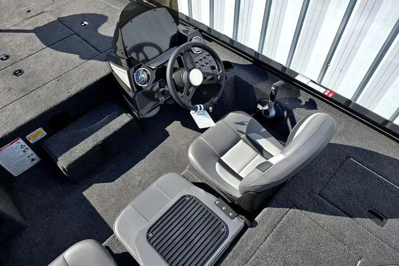 Slide: The Image of 2026 Lowe Stinger 175 boat interior with steering wheel and seating. - 2