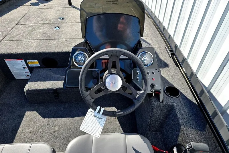 Slide: The Image of 2026 Lowe Stinger 175 boat cockpit with steering wheel and control panel. - 8